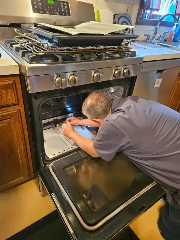 Mid America Service technician repairing a range and oven in St. Louis, Missouri