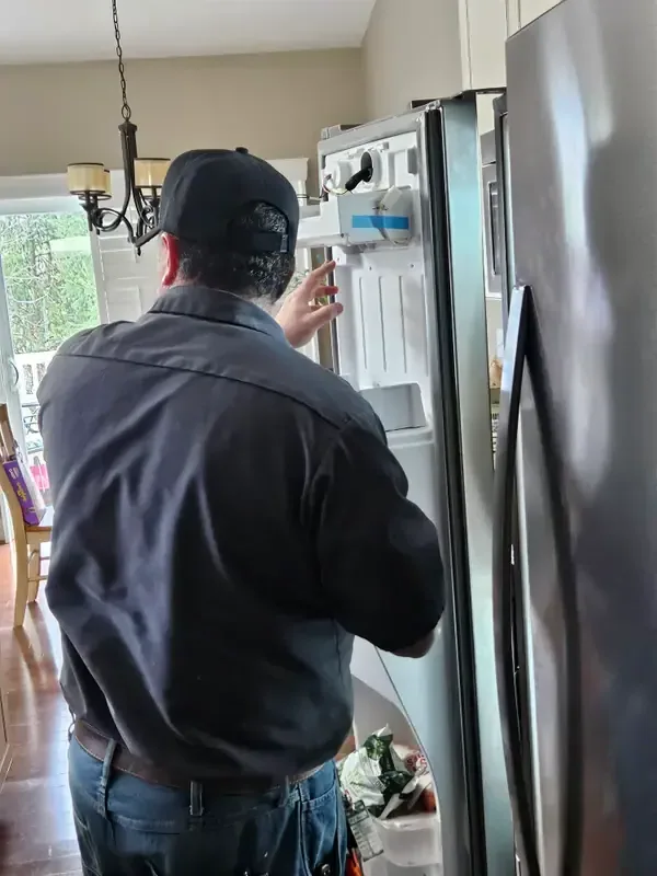 Mid America Service technician repairing a refrigerator in St. Louis, Missouri